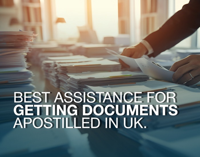 The image depicts a professional office setting with a person managing stacks of documents, illuminated by sunlight. The overlaid text reads: "Best assistance for getting documents apostilled in UK." It promotes expert apostille services, emphasizing efficient certificate authentication in the UK.
